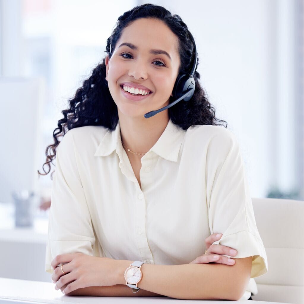 Portrait of a young call centre agent working on a computer in an office. Portrait of a young call centre agent working on a computer in an office.